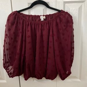 Burgundy top. Can be worn off shoulder. Elastic sleeves and waistband.